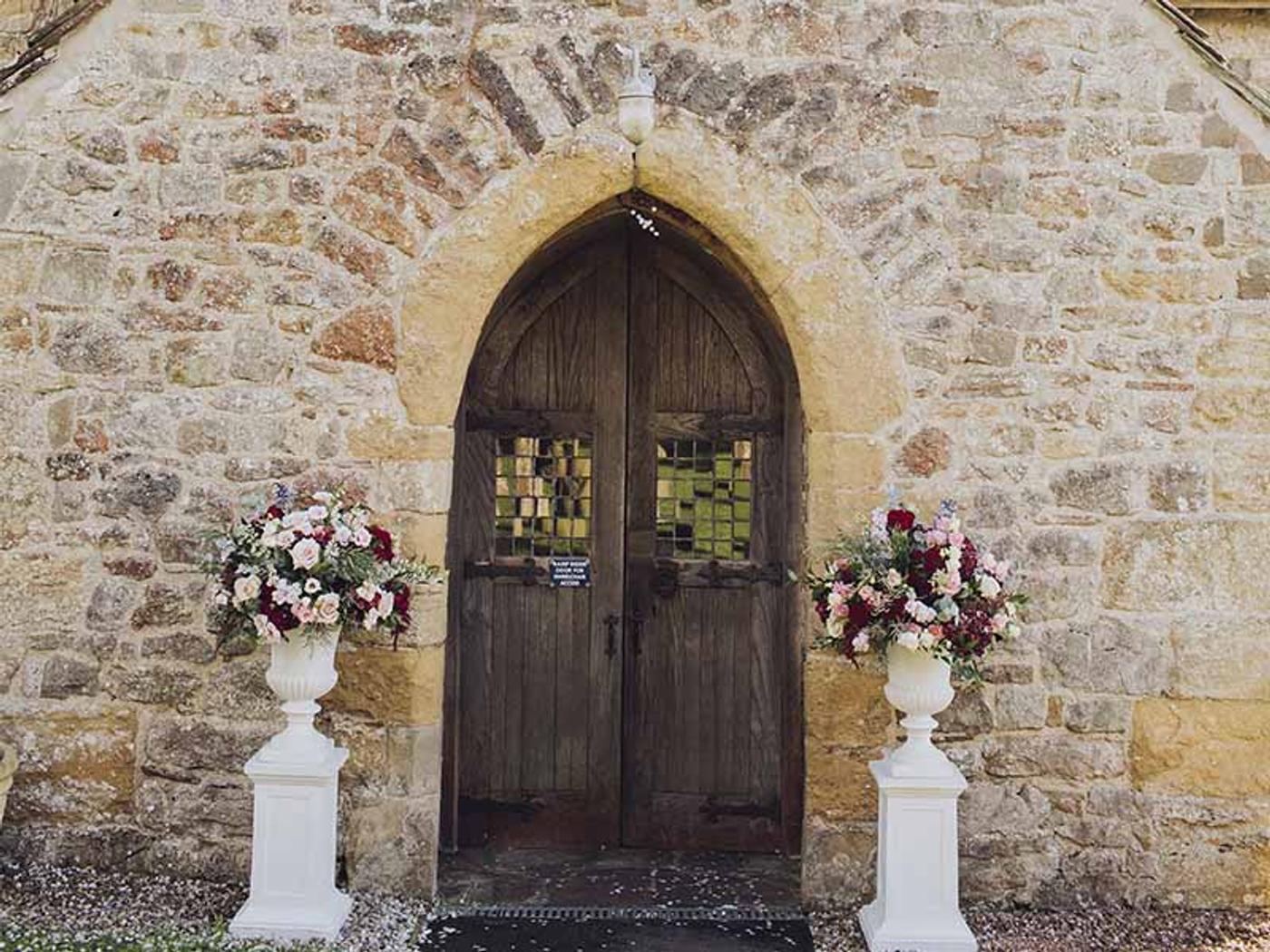 St. Peters Church's stone entrance decorated with flower urns