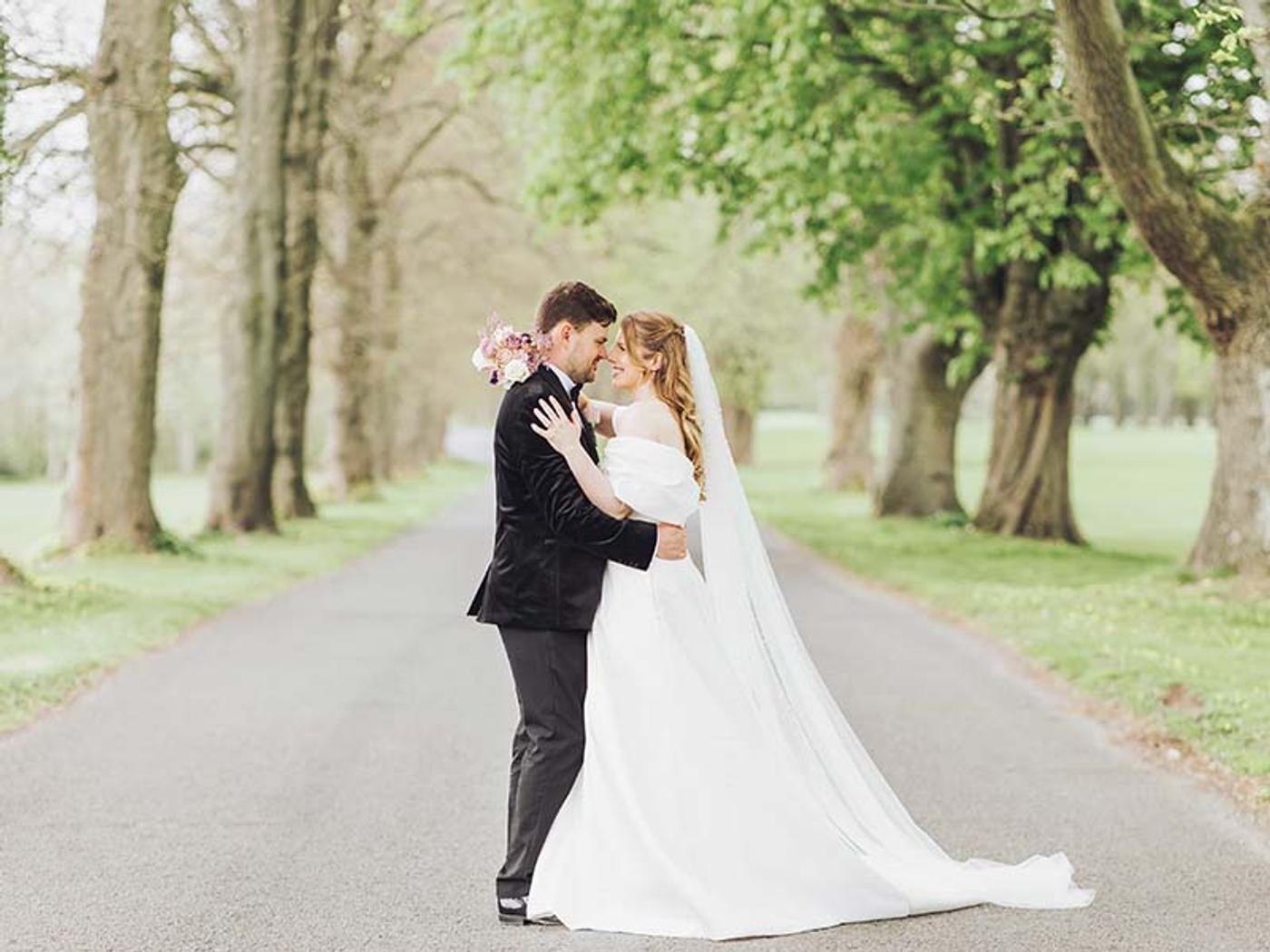 Couple embracing on the tree-lined driveway at Delta Hotels St. Pierre Country Club