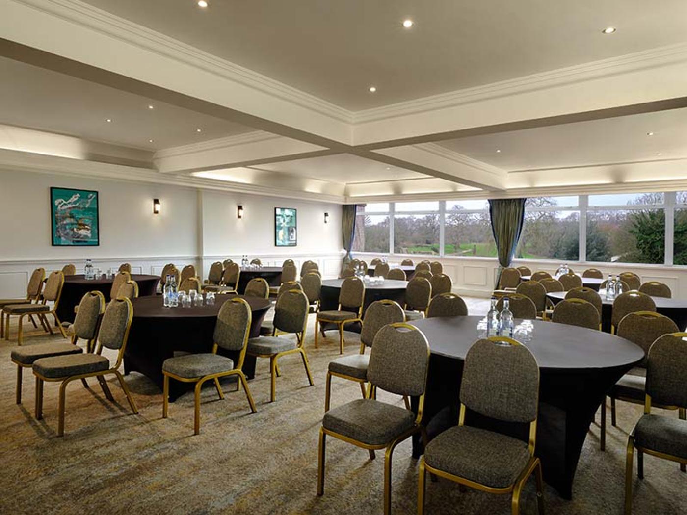 Chepstow Room set up boardroom-style with dark round tables
