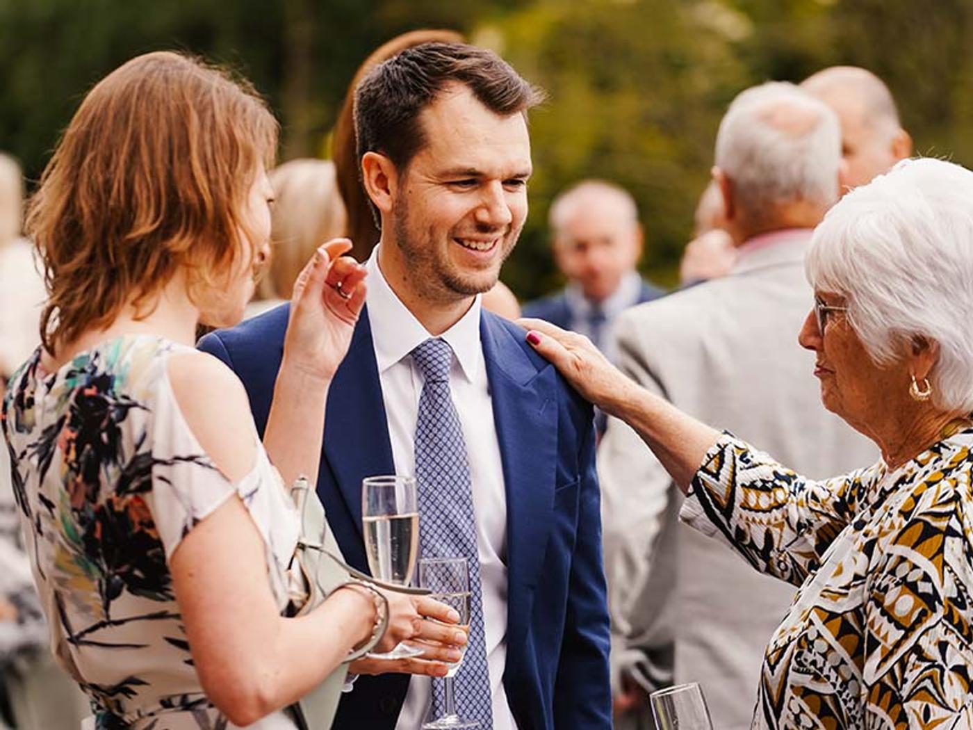 Newlyweds toasting with guests at Delta Hotels Breadsall Priory Country Club