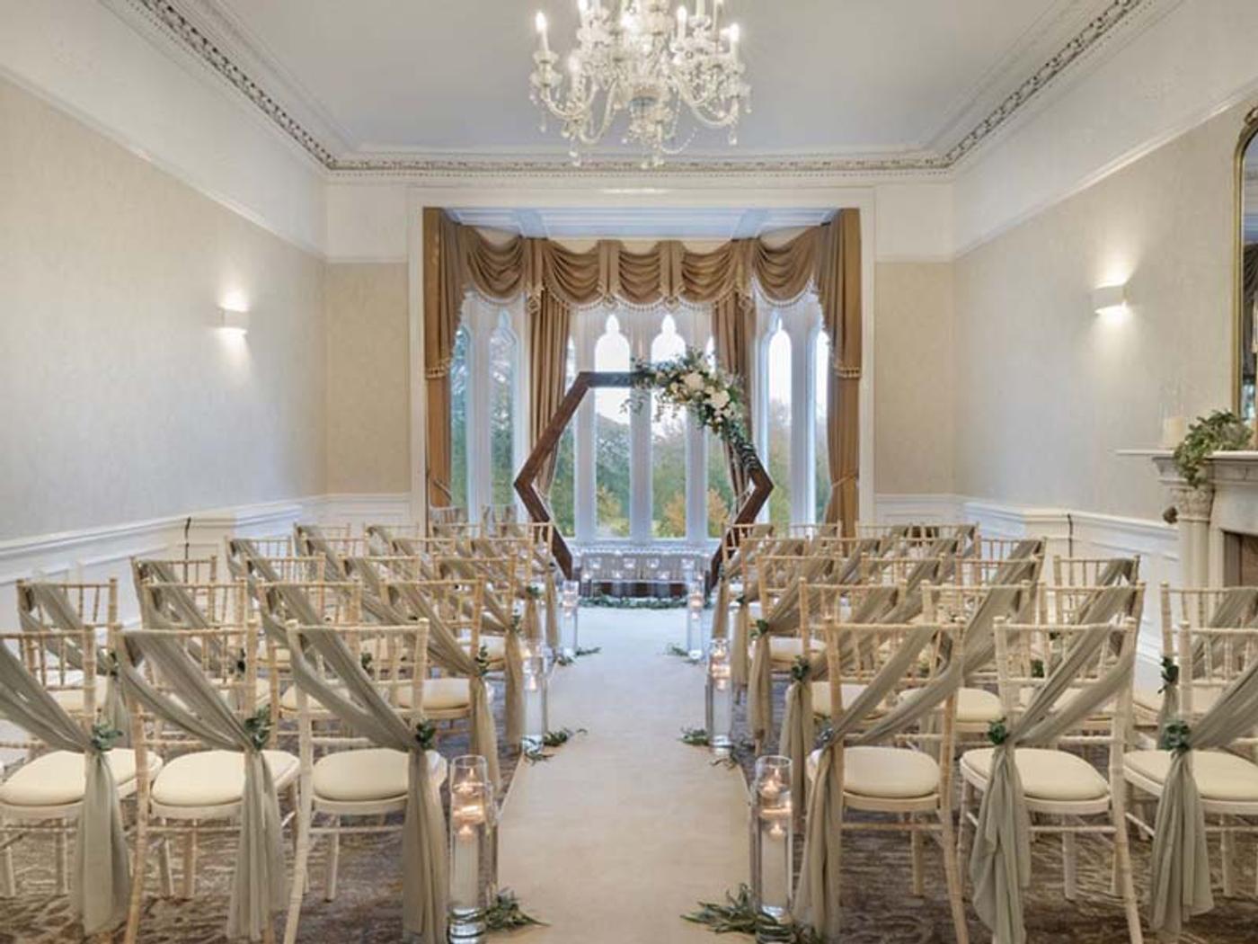 Morley Room set up for a civil ceremony with a hexagonal floral arch