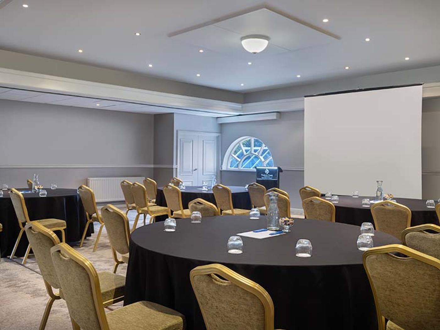Thurnham Room set boardroom-style with a projector screen
