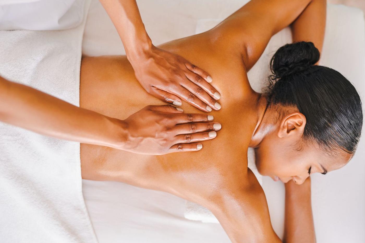 Guest enjoying a back massage treatment at the spa