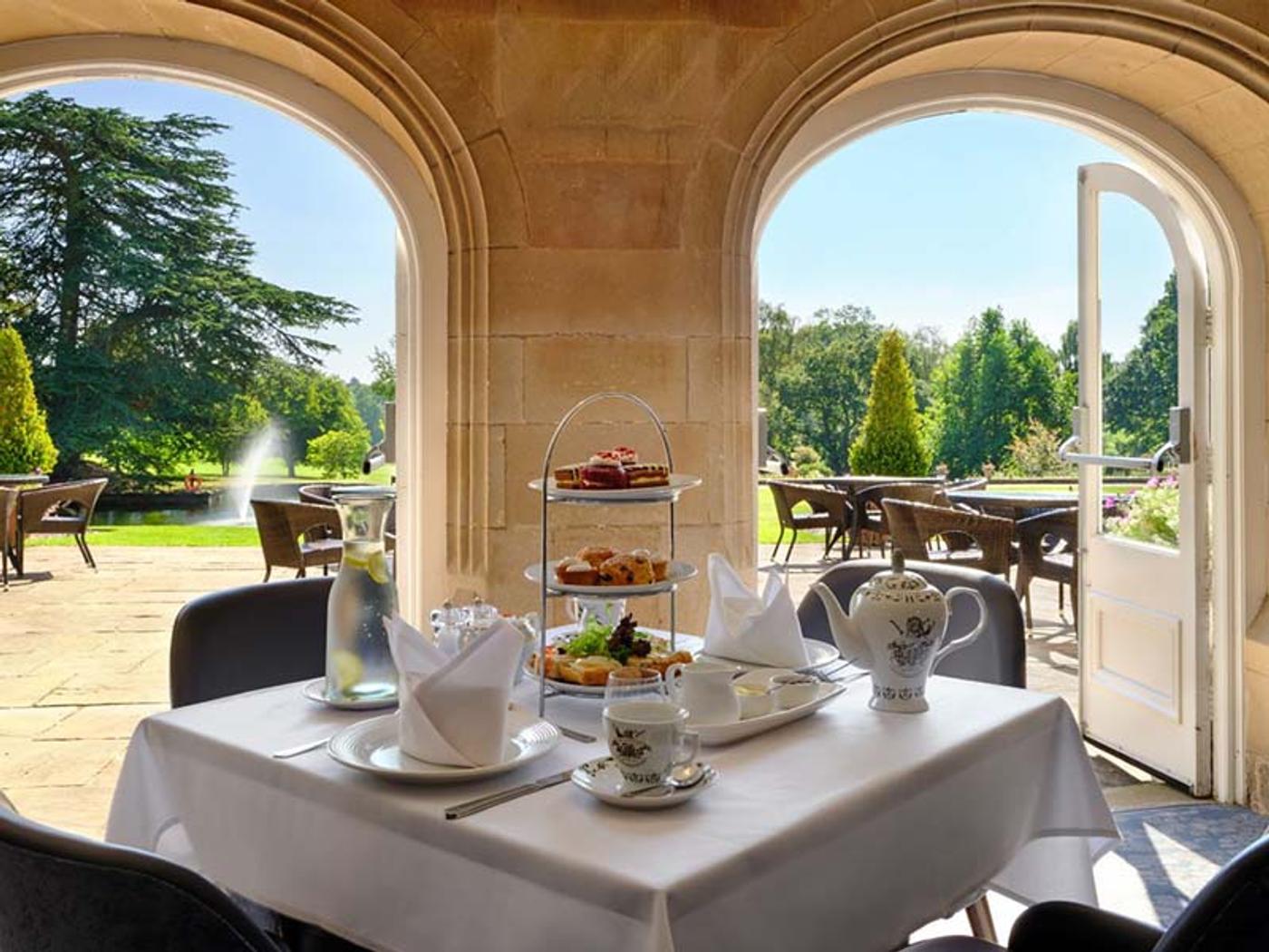 Afternoon tea served on the terrace overlooking the lake at Delta Hotels Breadsall Priory Country Club