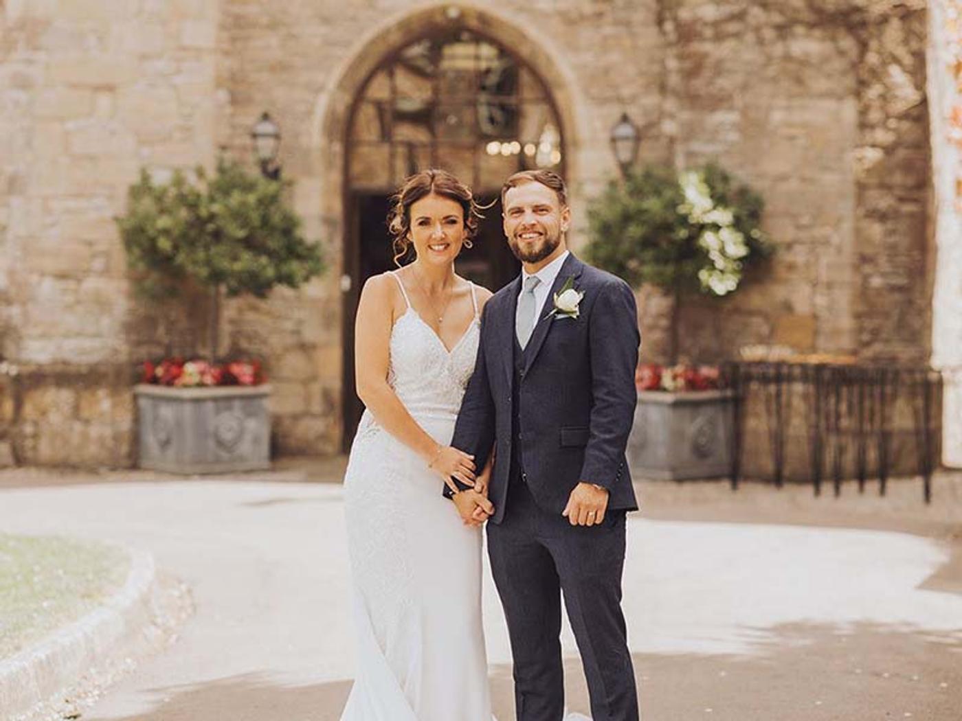Newlyweds outside Delta Hotels St. Pierre Country Club's courtyard archway