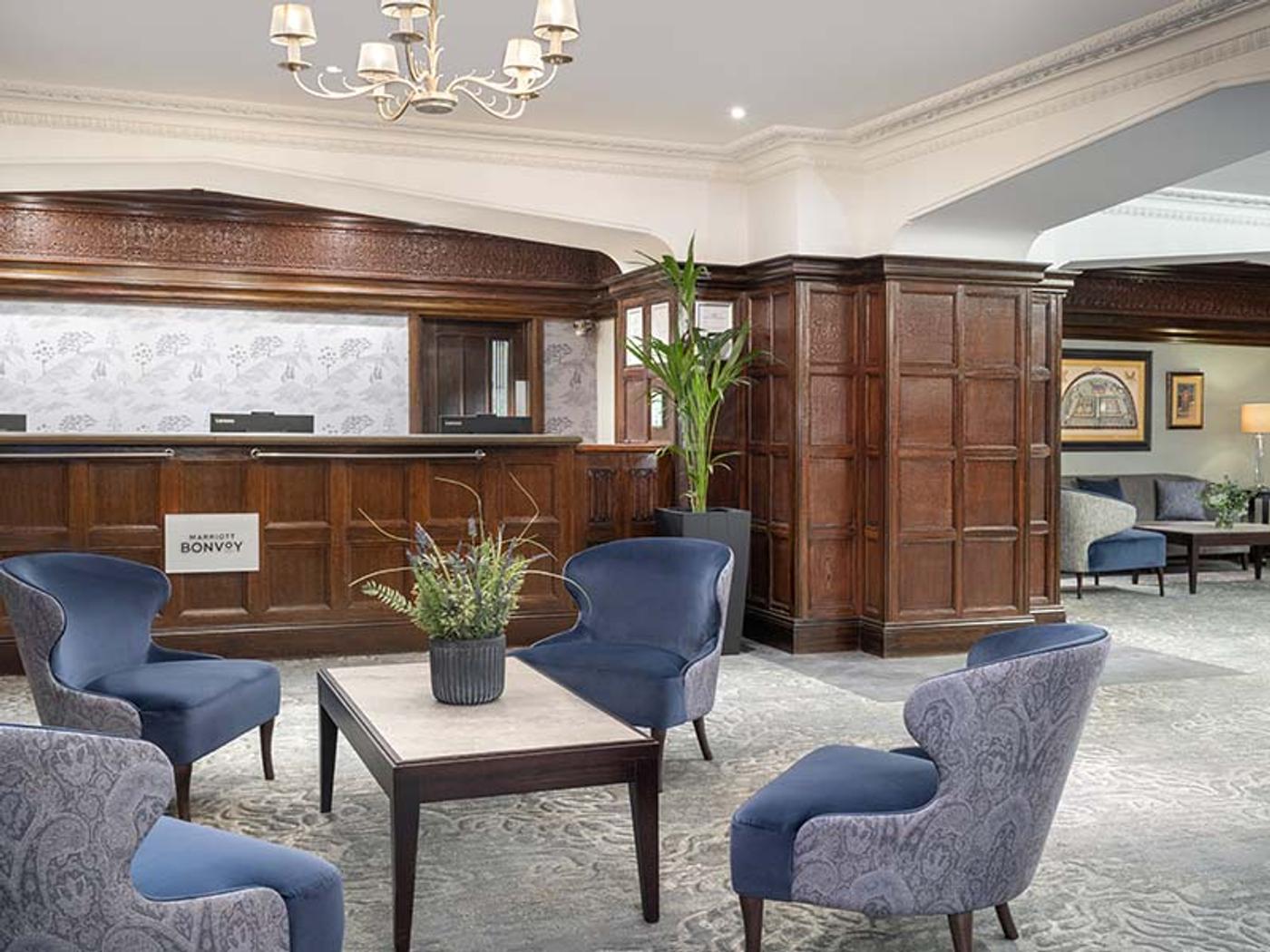 Marriott Bonvoy reception desk in the wood-panelled lobby at Delta Hotels St. Pierre Country Club