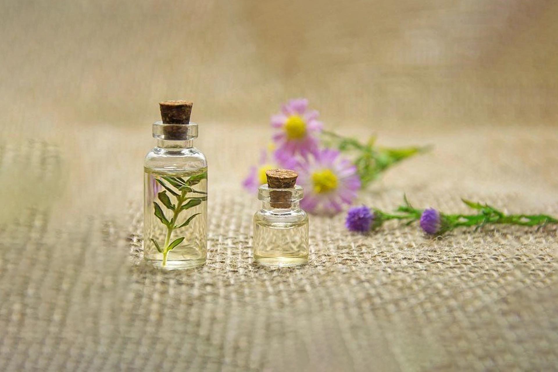 Bottles with clear liquid and flowers