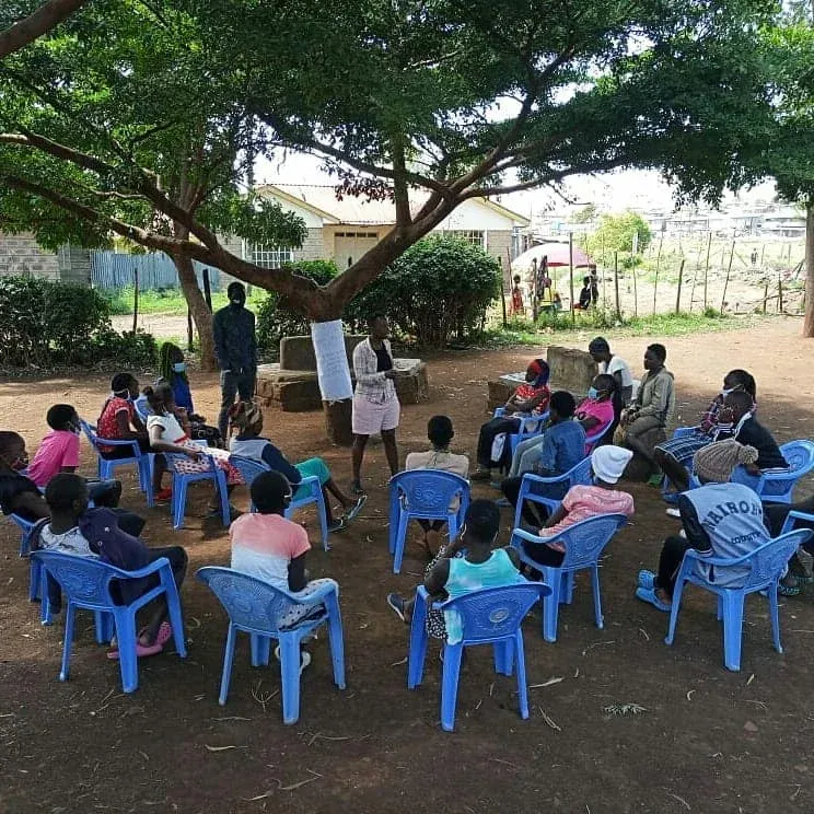 children recieving a talk outdoors