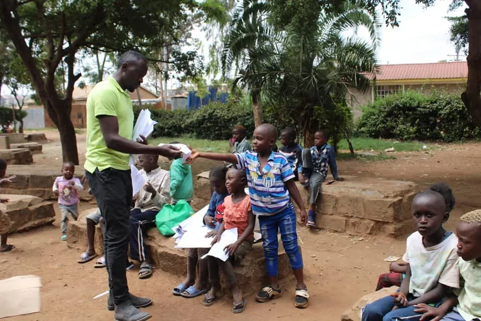 Volunteer handing out information to a child
