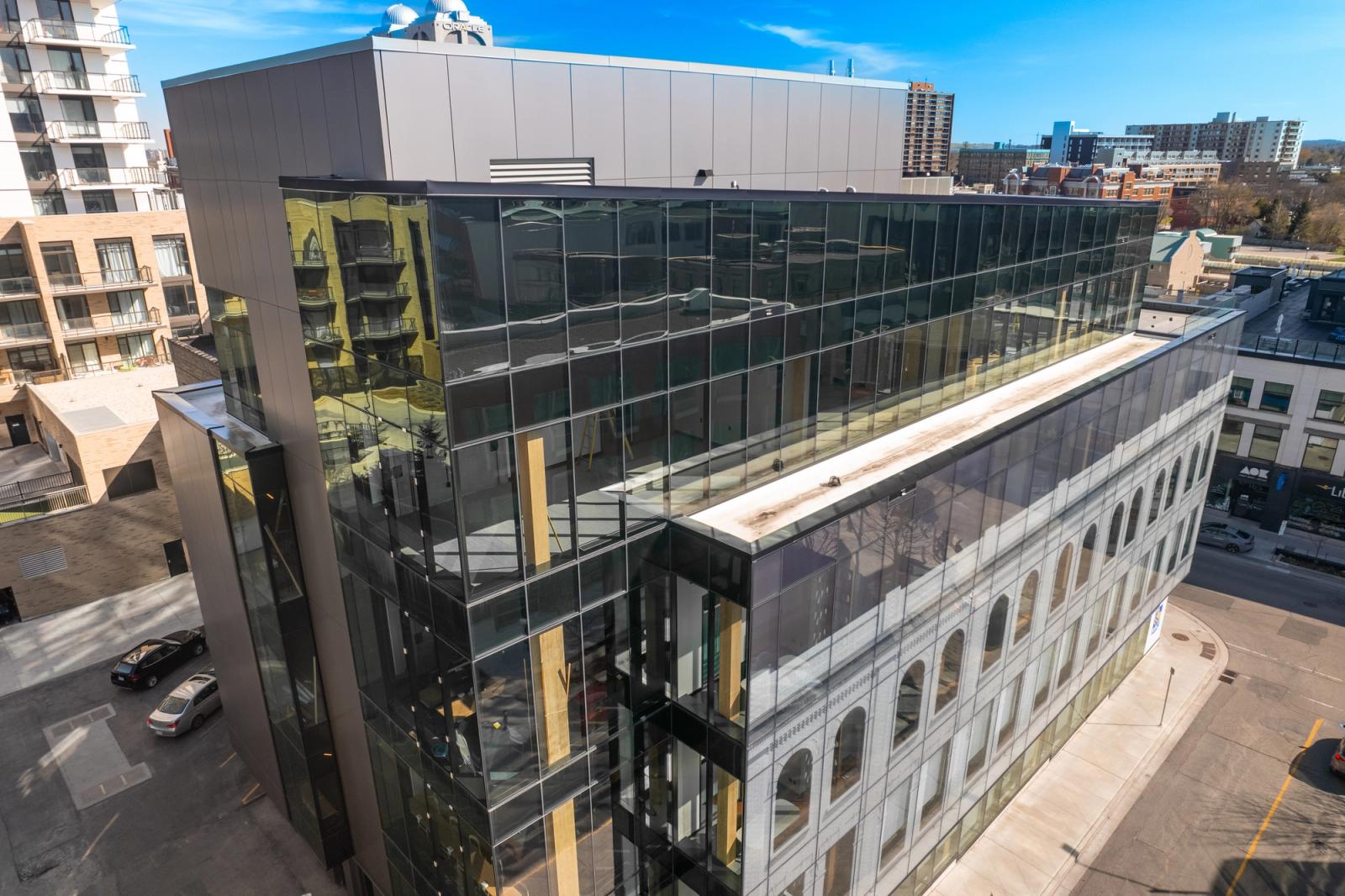 One Young Street in downtown Kitchener, with mass timber structure visible through the upper glass facade.