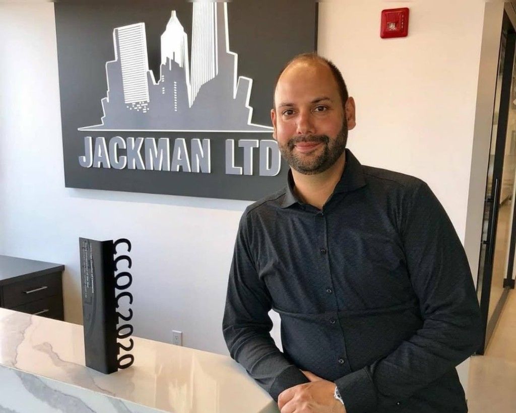 Eric Jackman with the Cambridge Chamber of Commerce Young Entrepreneur of the Year Award at the Jackman Ltd. office.