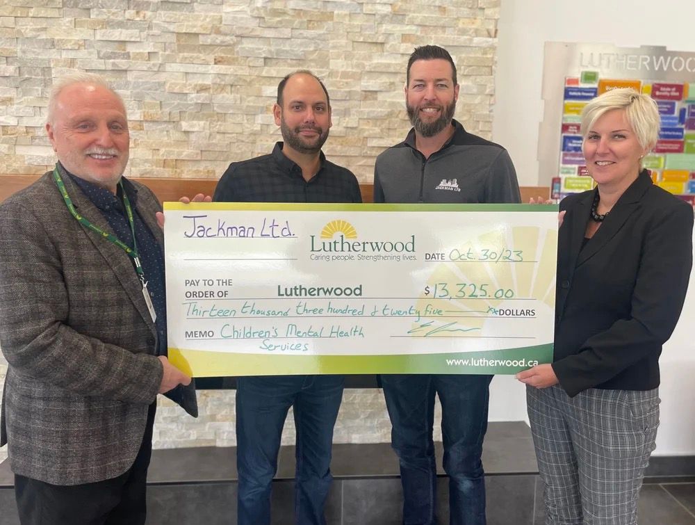 Jackman and Lutherwood representatives hold a $13,325 ceremonial cheque for Children's Mental Health Services, dated 30 October 2023.