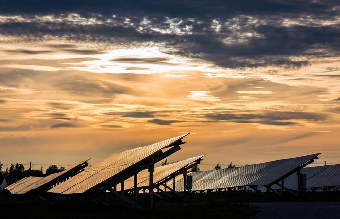 The sun sets over rows of solar panels at Summerside, P.E.I.'s 30-hectare Sunbank solar farm and battery storage facility.