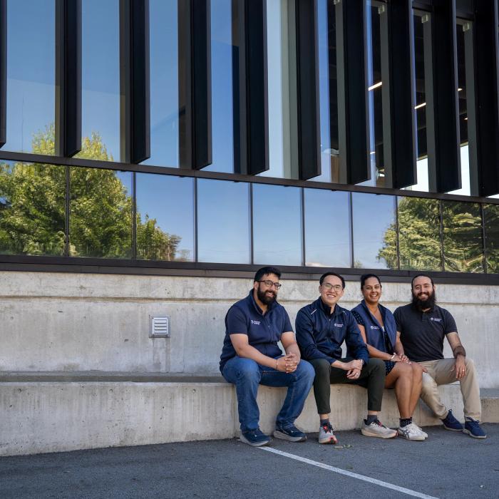 Gurmesh Sidhu, Edward Chiang, Sumreen Rattan and Gabriel Soares sit outside Moment Energy’s newest facility in Surrey, B.C. on Tuesday, June 16, 2026. The four co-founded the company in 2019 in a home garage, aiming to repurpose batteries into clean energy. Former engineering students at Simon Fraser University, the four co-founders first venture together was a meditation company. The new Surrey-based facility is expected to open by the end of June and claims to be the world’s largest in battery repurposing.