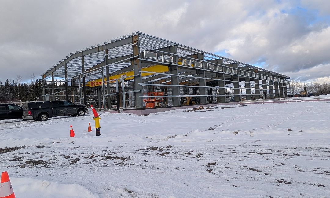 An under-construction facility at the modular home factory on a snowy winter landscape