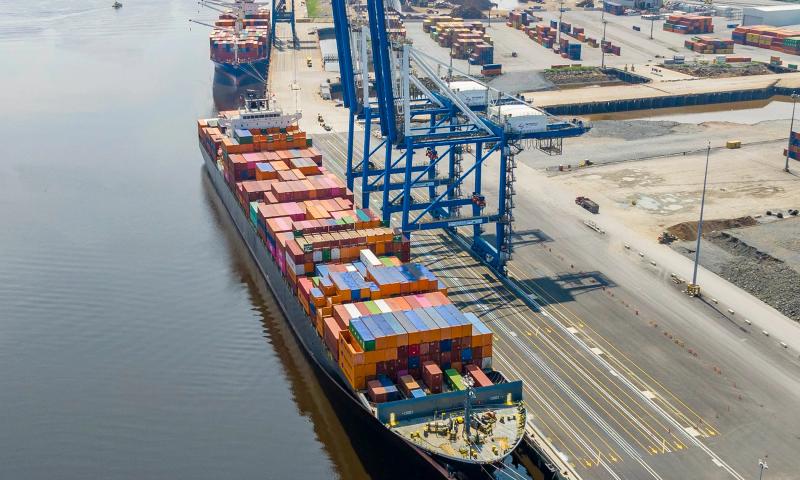 A cargo ship laden with shipping containers docked at Port Saint John.
