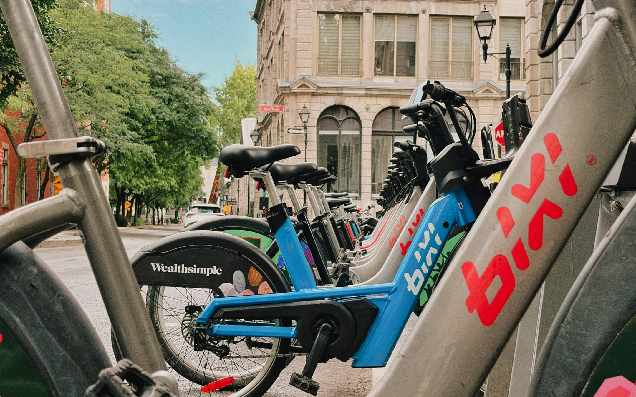A fleet of Montreal's BIXI bikes with Wealthsimple branding