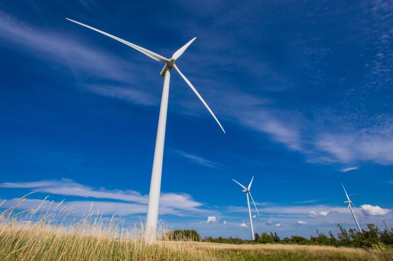Wind turbines stand 125 metres tall in fields outside Summerside, P.E.I. “Our goal is to grow our system and get it to 100 per cent renewable,” Sam Arsenault says.