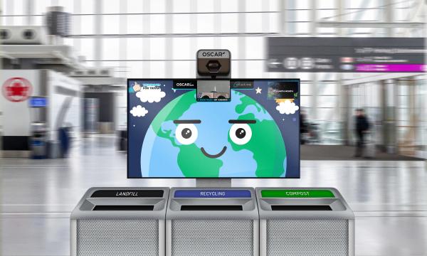 A photo illustration of Oscar Sort AI trash recycling, showing a yellow smiley face and camera on a screen above a set of three trash cans labelled "landfill" "recycling" and "compost"