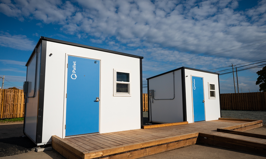 Two small prefabricated shelters at the Pallet Village in Cape Breton