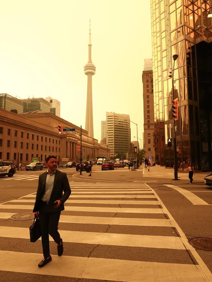 The skies above Toronto on July 15, 2026. Wildfire smoke is a toxic mix of fine particulate matter called PM 2.5 that can have both short-term and long-term health effects.