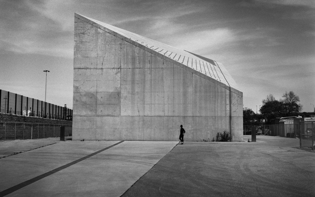 a portrait of architect Pat Hanson, shown in silhouette outside Toronto's Cherry Street Stormwater Management