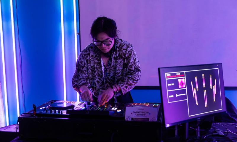 A DJ plays at an AI-powered rave at the Socratica symposium