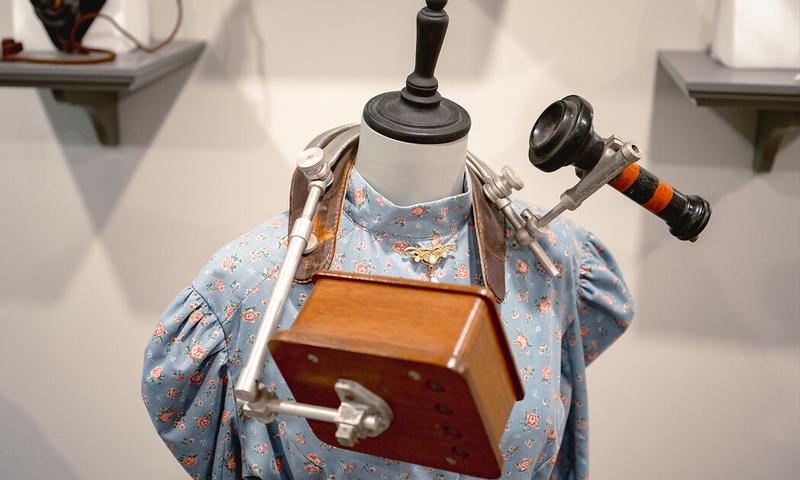 Details of objects from the Bell Homestead National Historic Site in Brantford, Ont. including an old phone receiver and a blue floral dress on a mannequin