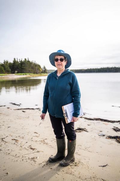 Colleen Boudreau, Little Dover’s postmaster, on the beach at Black Duck Cove Provincial Park. (Chris Donovan / Be Giant)