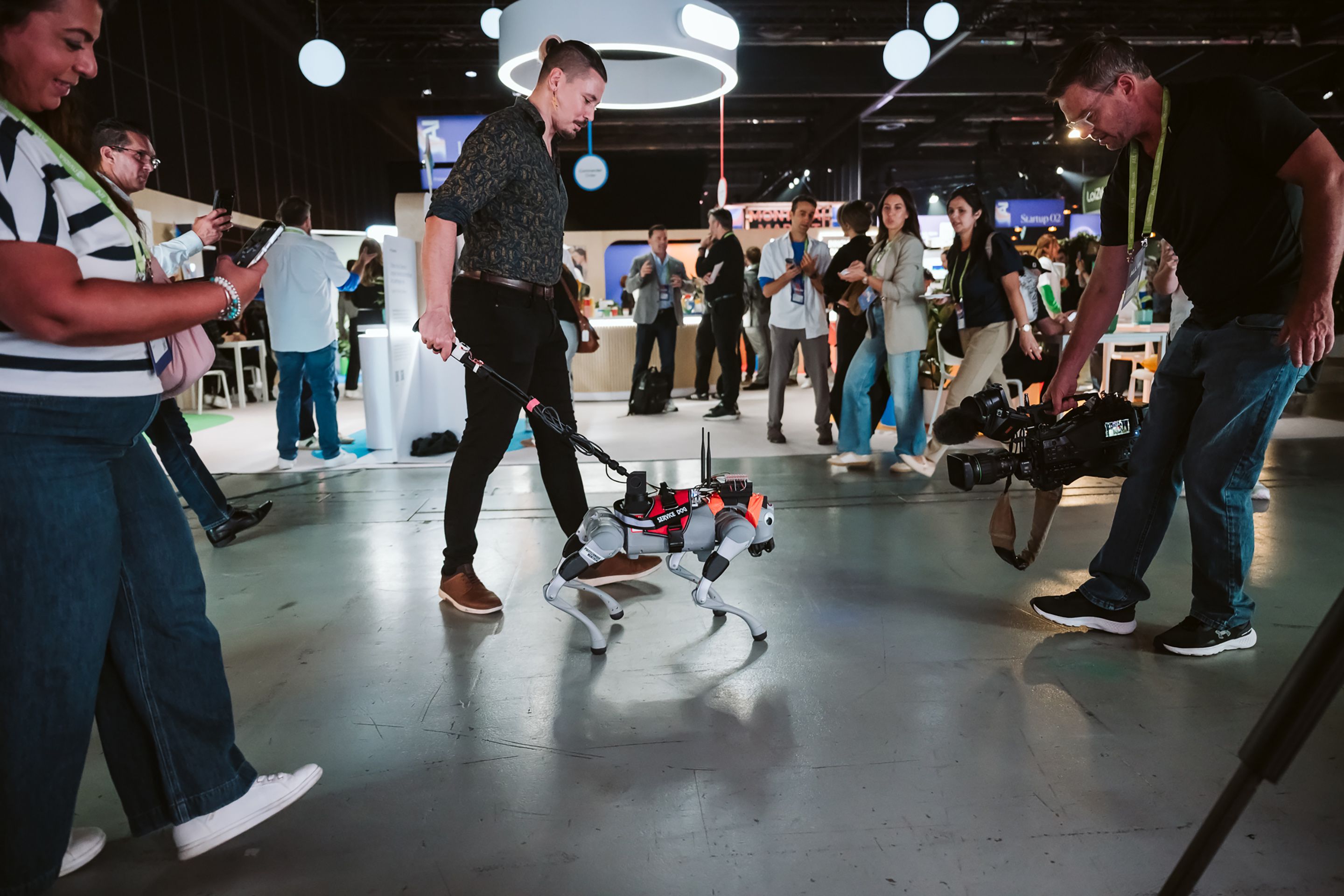 Milo, Mila's robot guide dog, at All In in Montreal. Robotic arms, drones and other mechanical entities dotted the conference's trade show floor.
