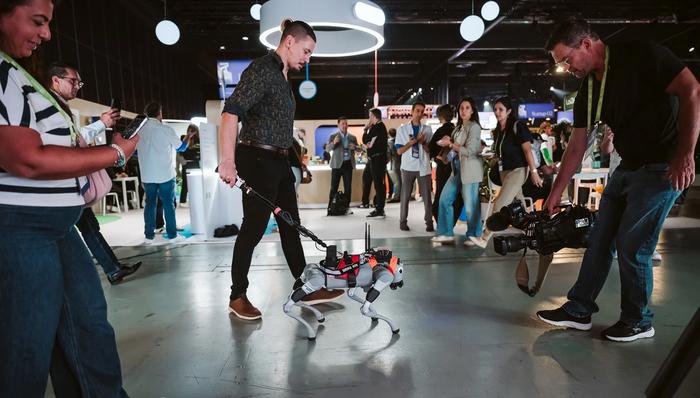 Milo, Mila's robot guide dog, at All In in Montreal. Robotic arms, drones and other mechanical entities dotted the conference's trade show floor.