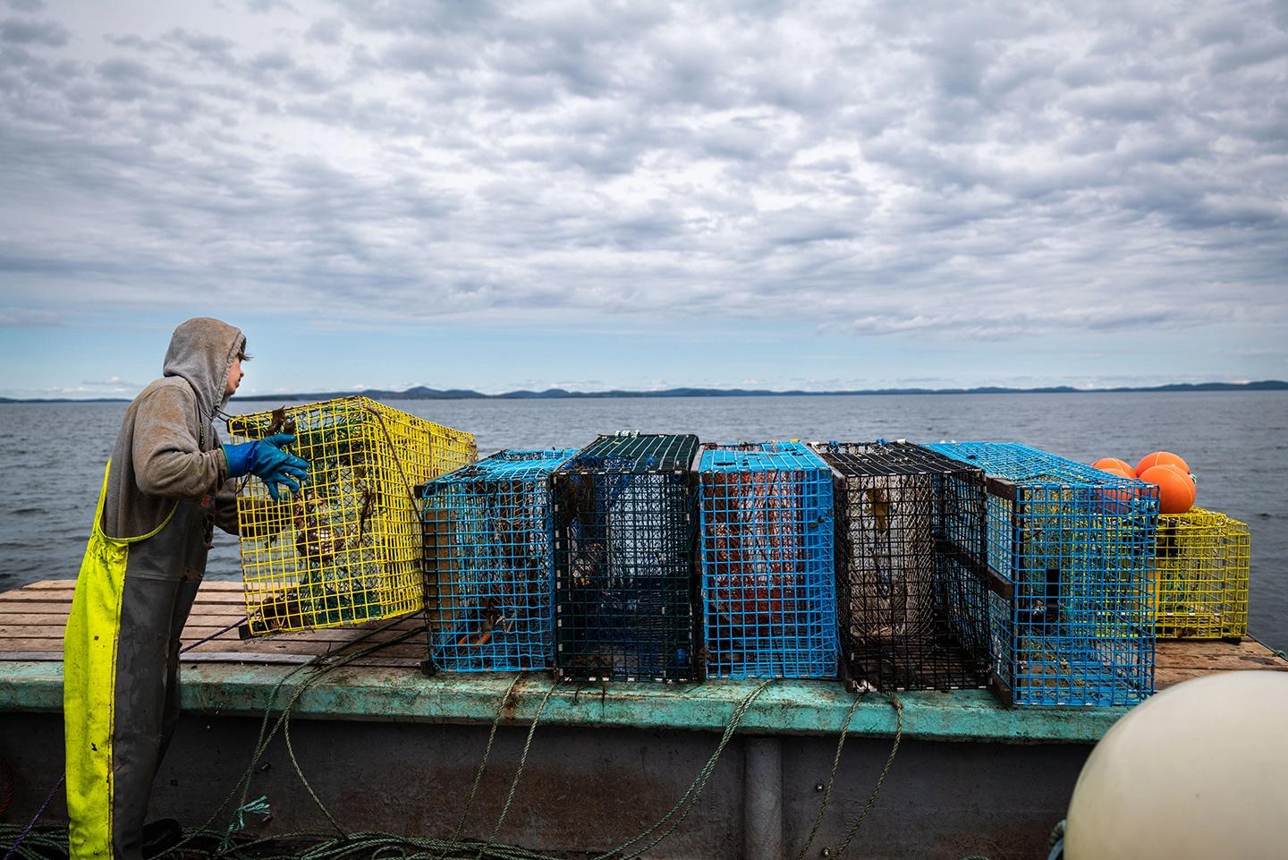 A fisher working on a set of ropeless fishing traps.
