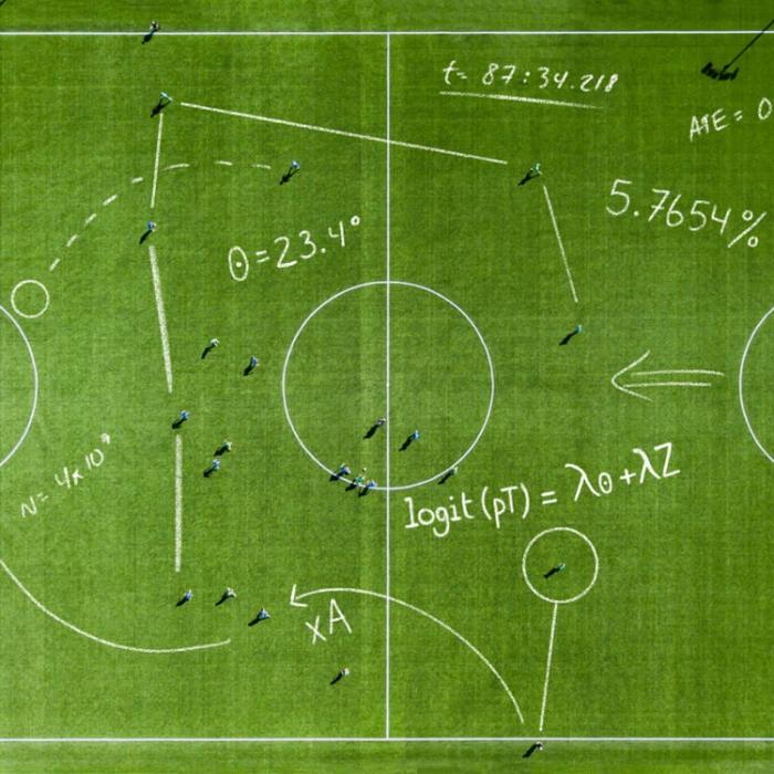 Aerial view of a soccer pitch overlaid with hand-drawn statistical equations, angles, and analytics notations