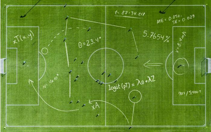 Aerial view of a soccer pitch overlaid with hand-drawn statistical equations, angles, and analytics notations