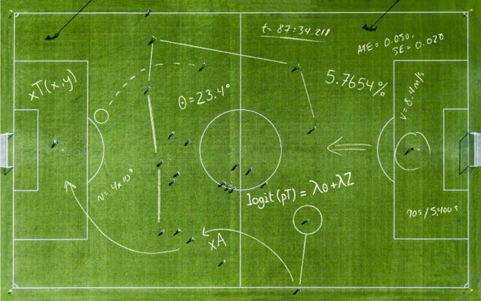Aerial view of a soccer pitch overlaid with hand-drawn statistical equations, angles, and analytics notations