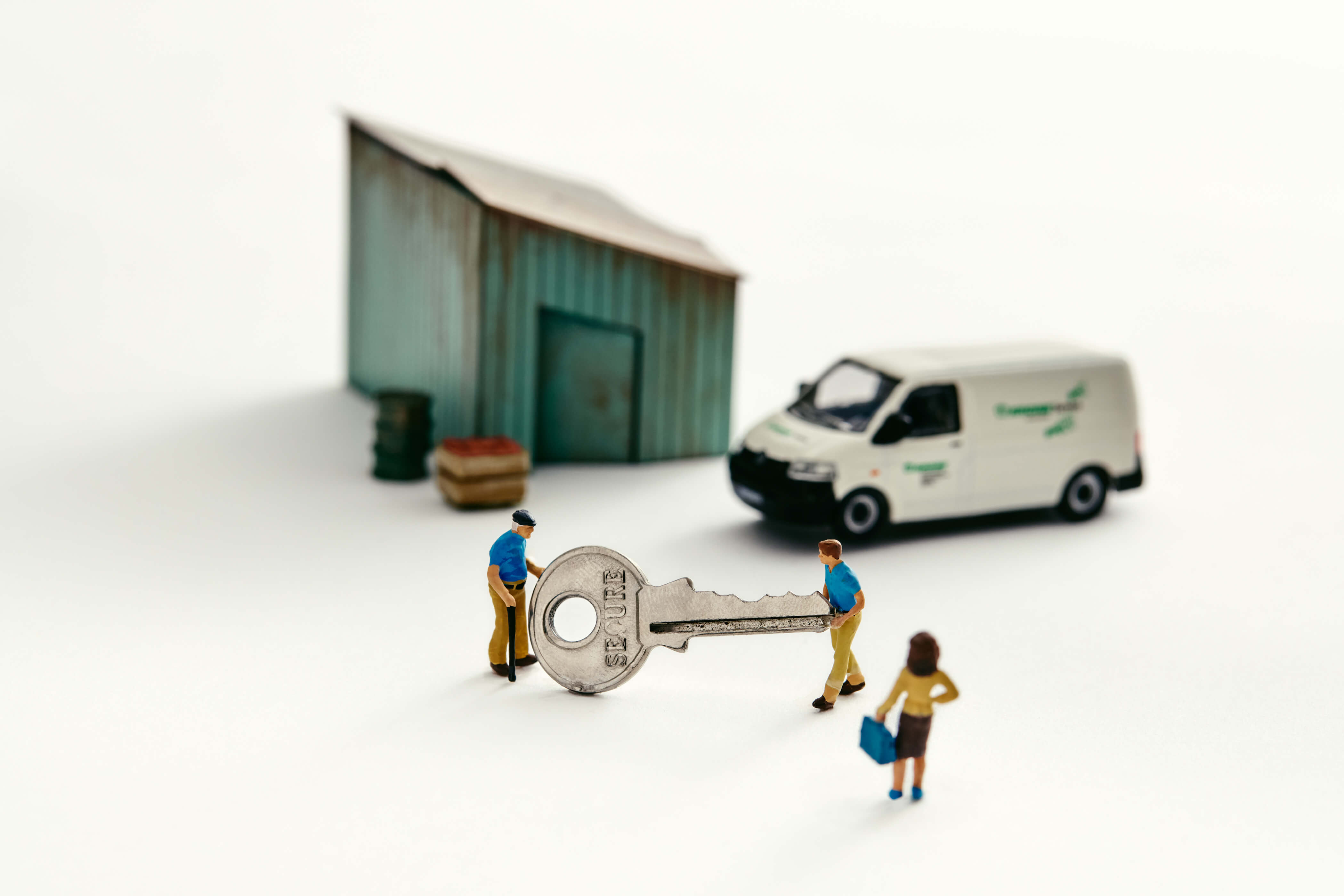 a photo illustration of a miniature shed with a van and two people holding a giant key with a woman looking on for a piece on how young people are taking over family businesses in Canada