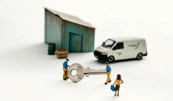 a photo illustration of a miniature shed with a van and two people holding a giant key with a woman looking on for a piece on how young people are taking over family businesses in Canada