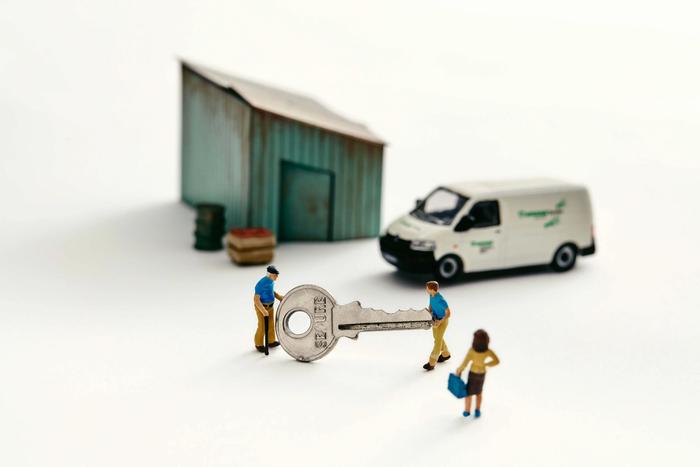 a photo illustration of a miniature shed with a van and two people holding a giant key with a woman looking on for a piece on how young people are taking over family businesses in Canada