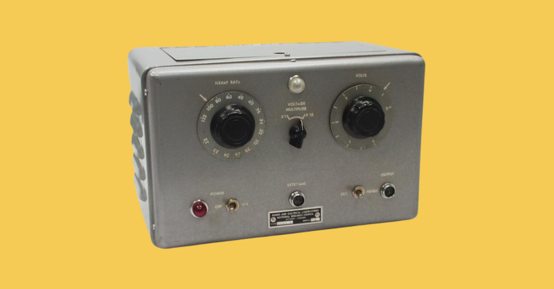 A grey pacemaker on a yellow background