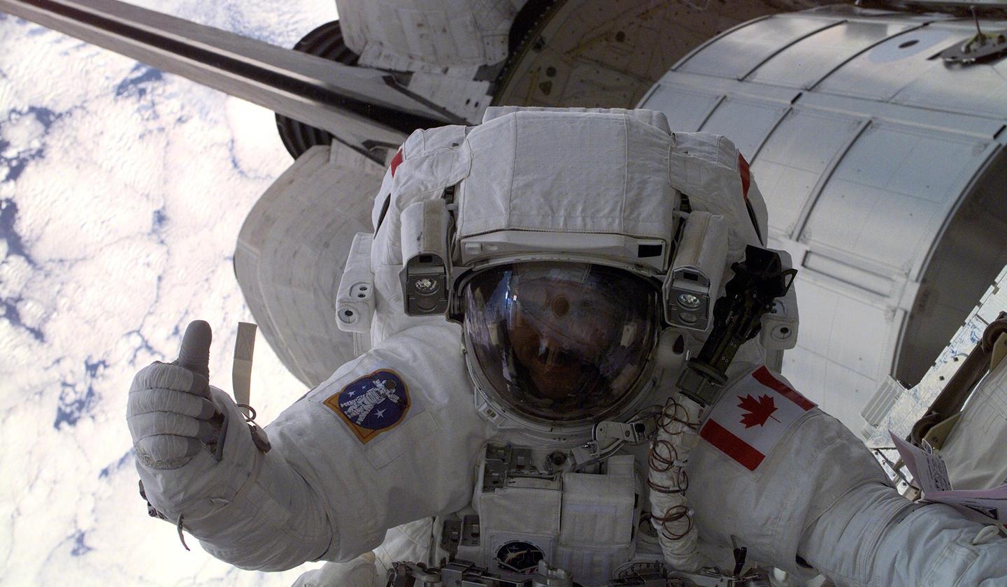 Canadian Space Agency (CSA) astronaut Chris Hadfield gives fellow astronauts the thumbs up during the first space walk (EVA-1) of the STS-100 mission.