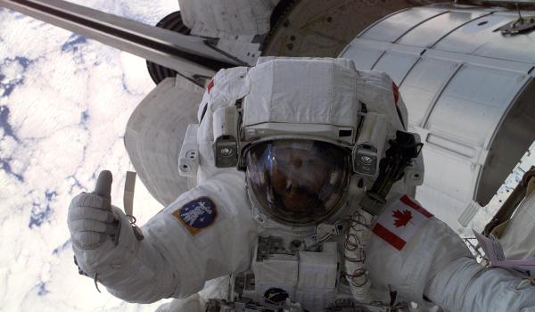 Canadian Space Agency (CSA) astronaut Chris Hadfield gives fellow astronauts the thumbs up during the first space walk (EVA-1) of the STS-100 mission.