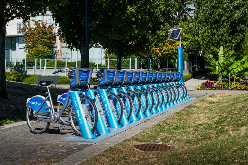 Many bike share bikes in a row at a bike rental station in Vancouver