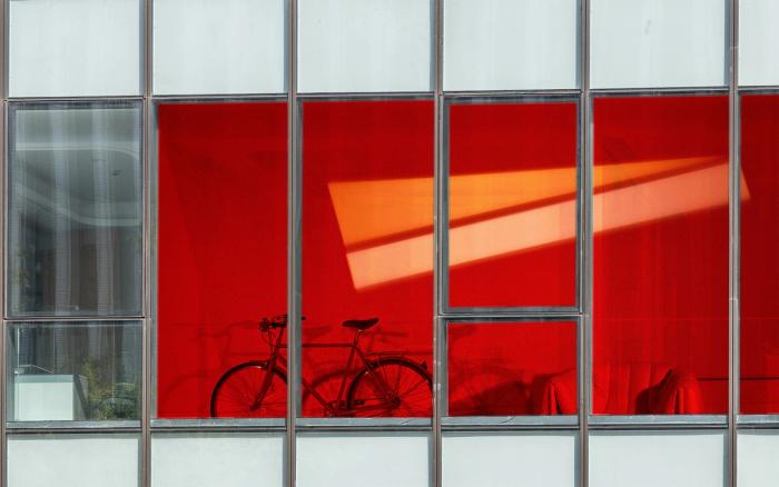 An artist's interpretation of how the squid-inspired window would work if installed in a commercial building, with colours representing changes in heat and light