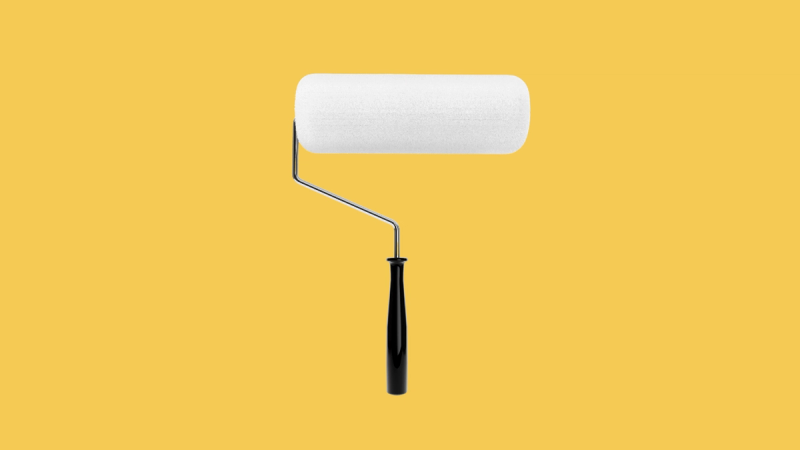 white paint roller on yellow background