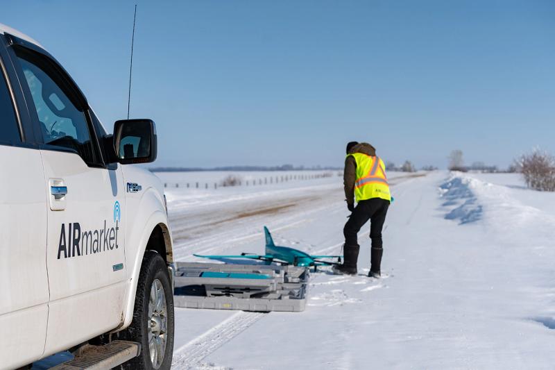 A drone operator getting the drone ready for the test flight. The AIRmarket drones have 2.3-metre-wide fixed wings.