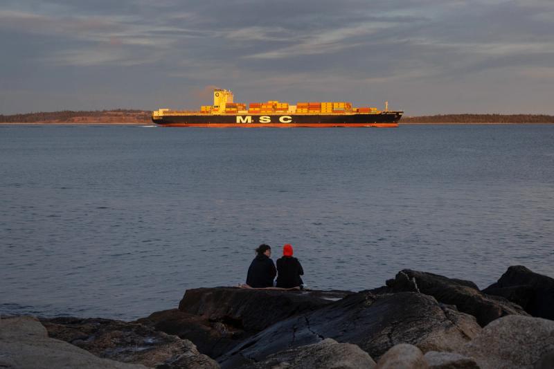 MSC shipping boat crosses the ocean at sunset from Halifax port