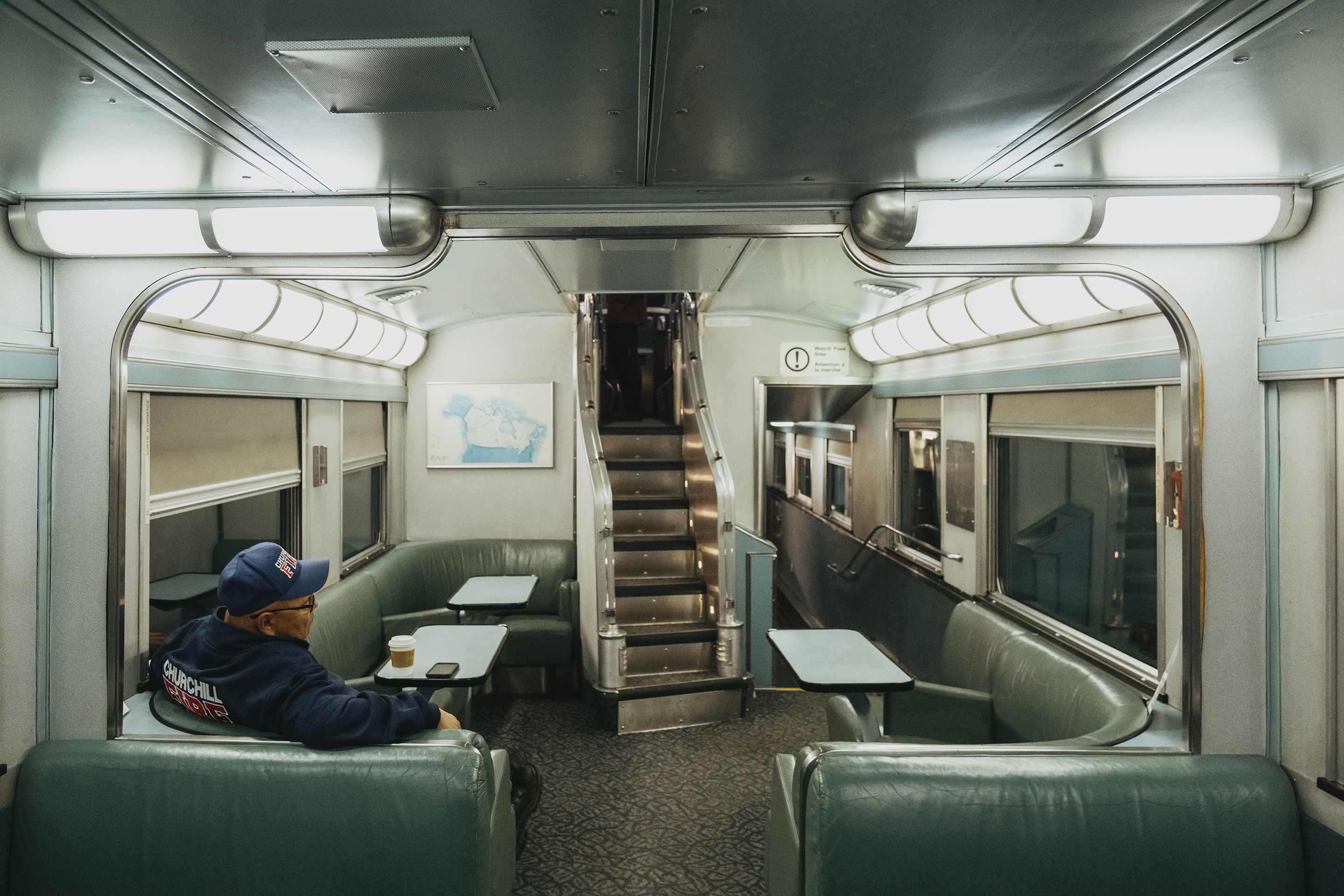A passenger sits in a dining car on the train from Churchill, Manitoba on September 26. 2026.