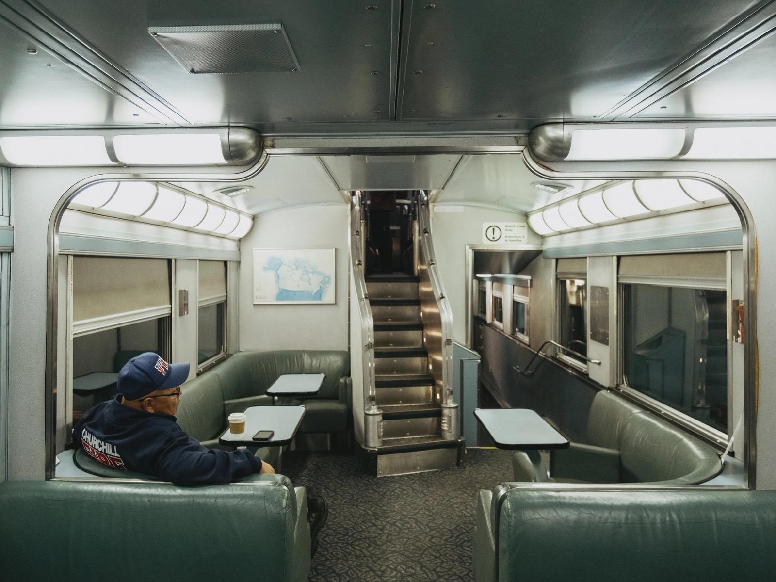 A passenger sits in a dining car on the train from Churchill, Manitoba on September 26. 2026.
