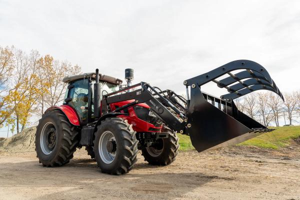 A completed Ursa Ag tractor fitted with a front-end loader and grapple bucket sits outside the company's shop in Bowden, Alta., on Oct. 5, 2026. Ursa Ag builds deliberately low-tech tractors designed so that farmers can repair them themselves. (Photo: Bryce Meyer / Be Giant)