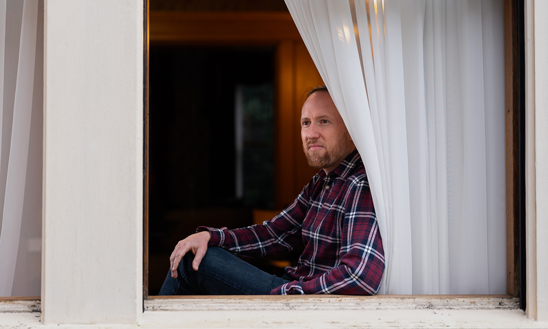 Benjamin Sanders Sitting at a window